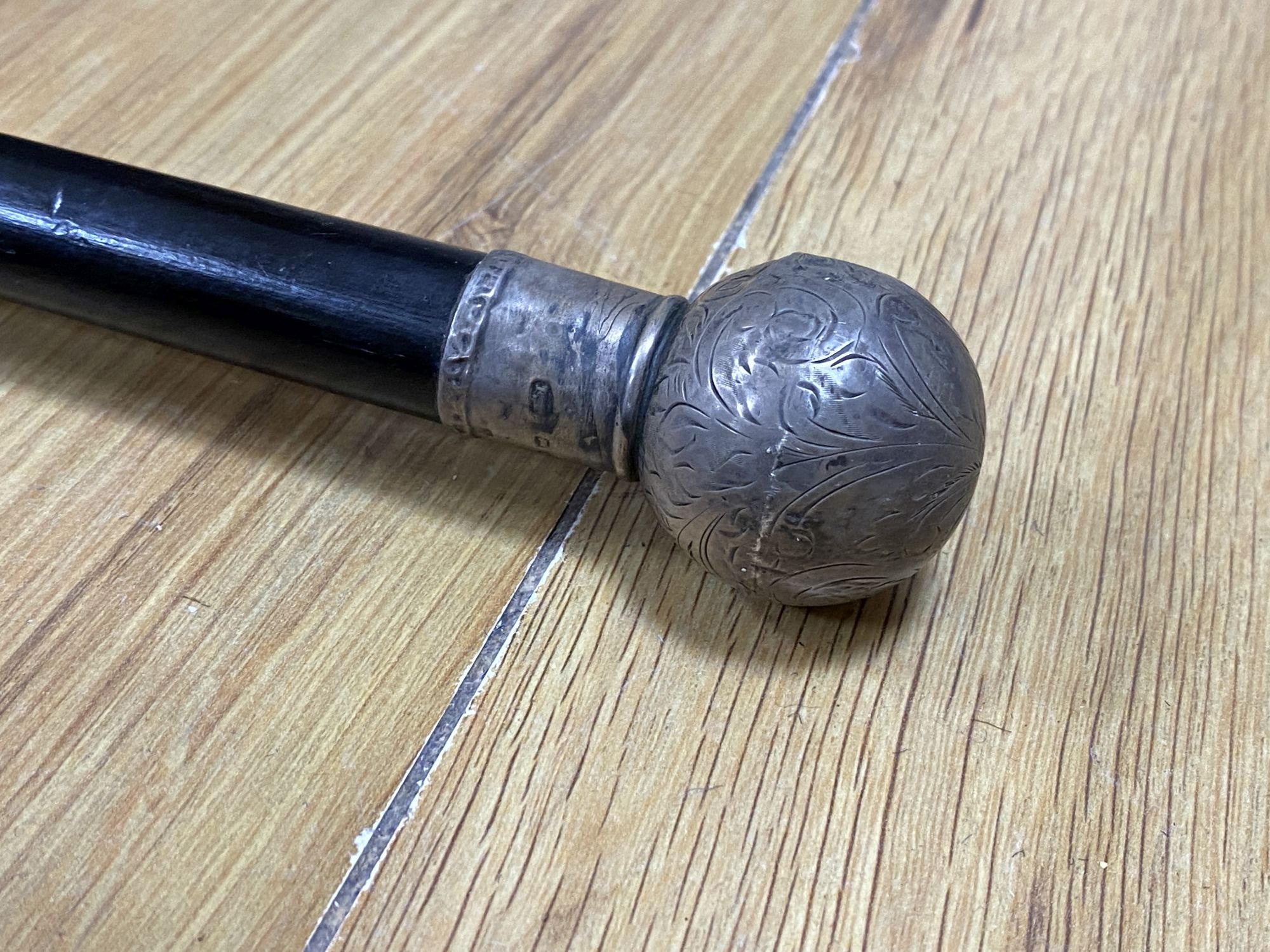 A Victorian silver mounted cane, a wheel barometer and a mantel barometer